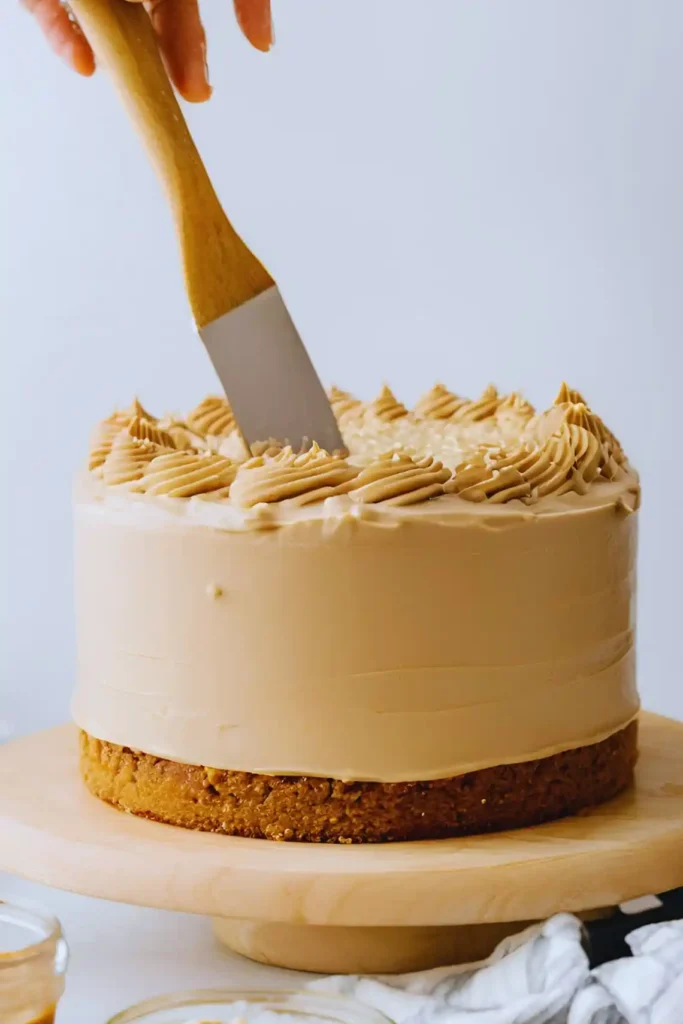 Frosting a peanut butter cake